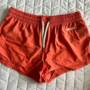 Vuori Clementine Women's Athletic Shorts in Orange/ Coral